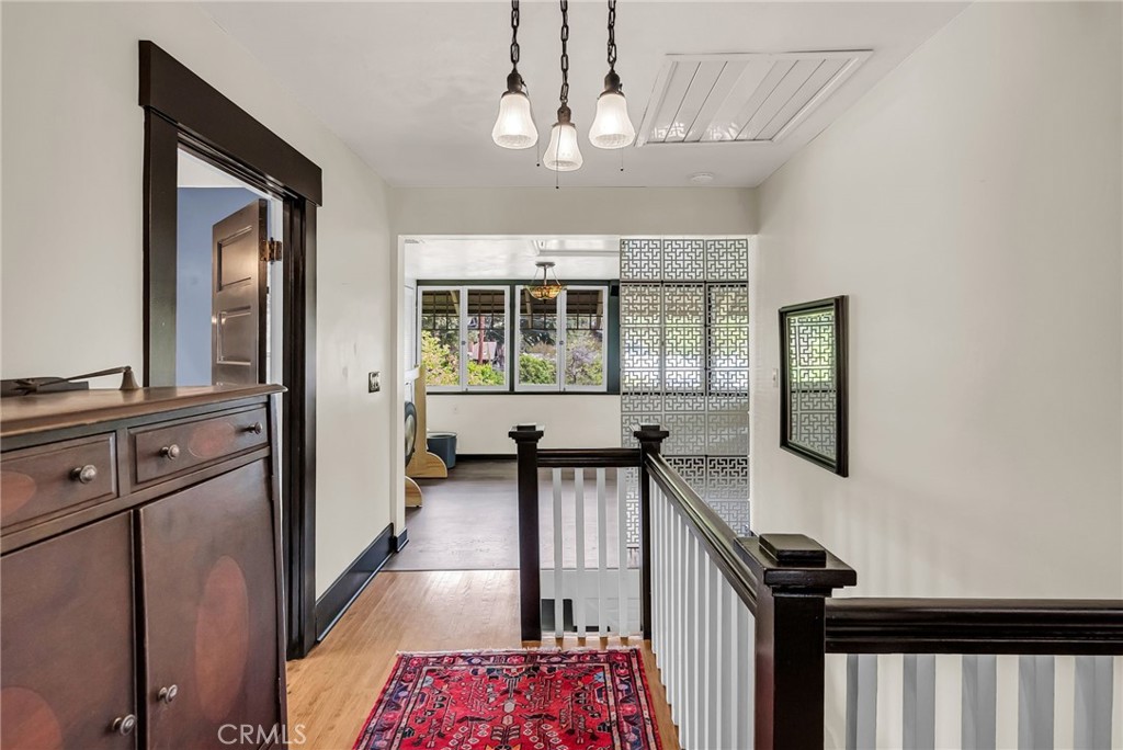 4465 5th Street Riverside, CA 92501 - Photo 30 of 56 a view of a hallway with wooden floor and a chandelier