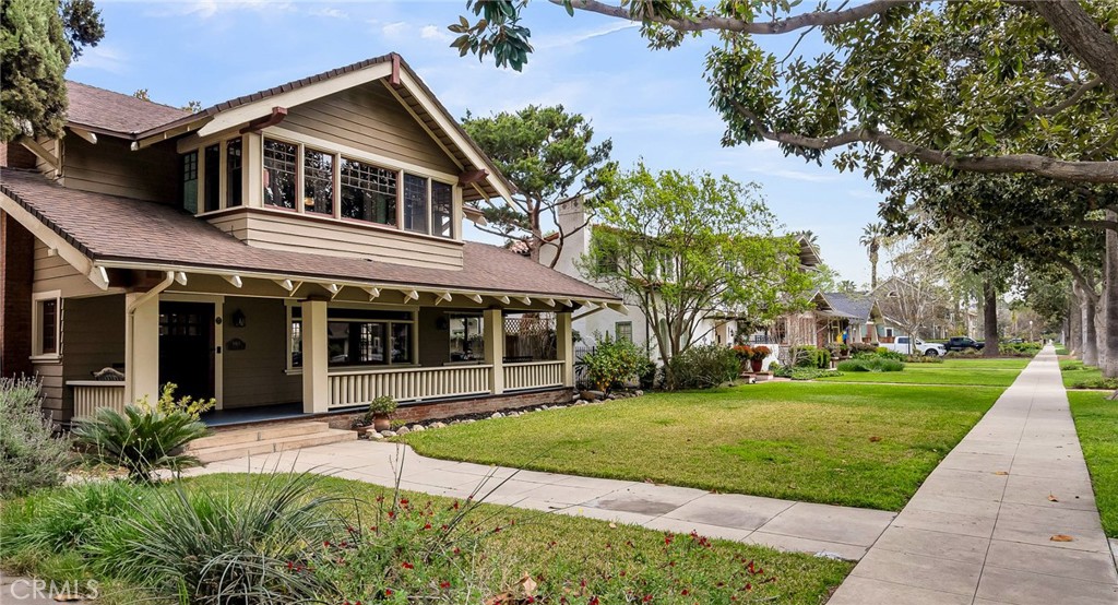 4465 5th Street Riverside, CA 92501 - Photo 3 of 56 a front view of a house with a yard and potted plants