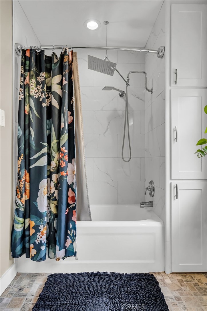 4465 5th Street Riverside, CA 92501 - Photo 35 of 56 a bathroom with a bathtub and a shower