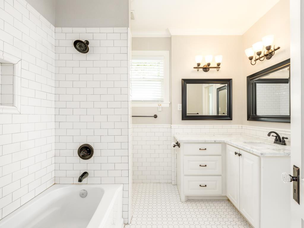 4528 Avenue R 1/2 Galveston, TX 77551 - Photo 20 of 22 a bathroom with a bathtub sink vanity and mirror