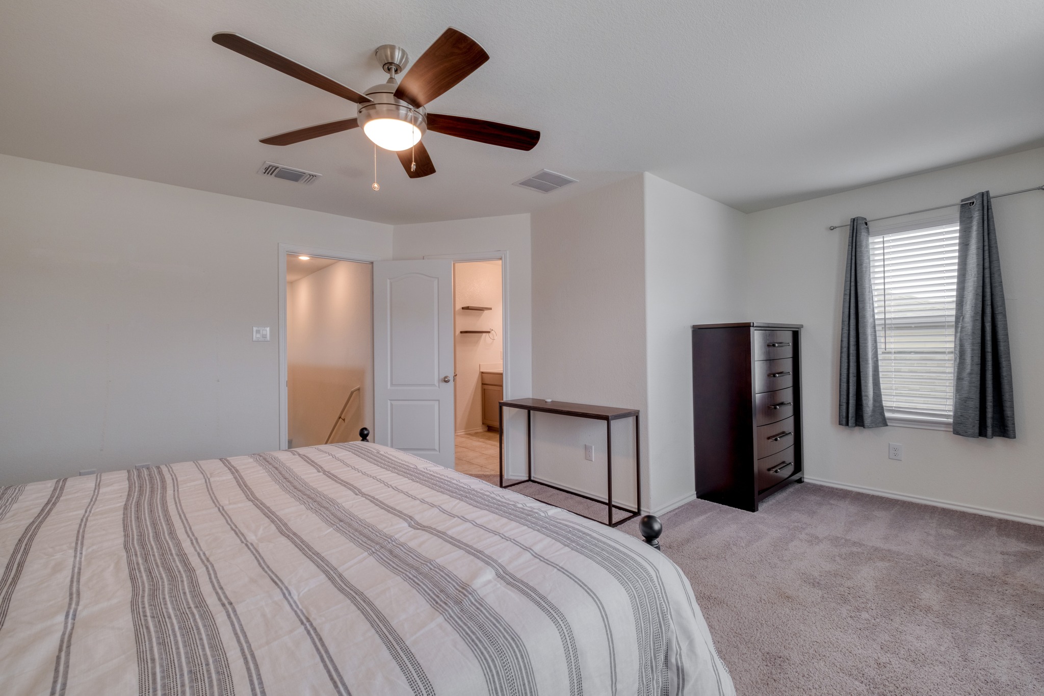 508 Barbary Coast Lane Jarrell, TX 76537 - Photo 16 of 27 a bedroom with a large bed and a ceiling fan