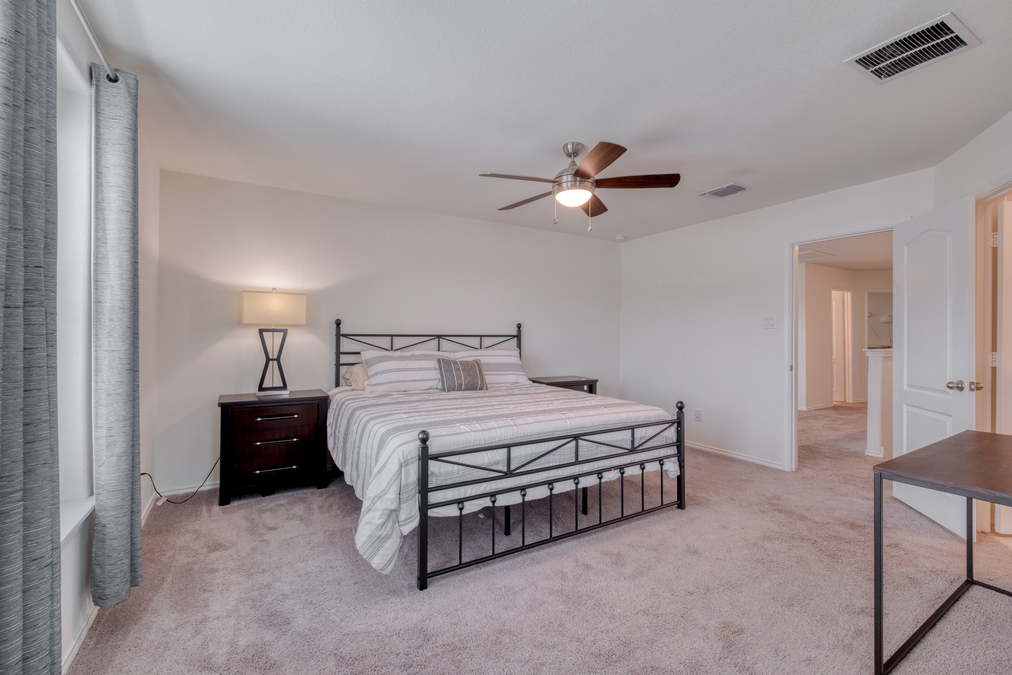 508 Barbary Coast Lane Jarrell, TX 76537 - Photo 17 of 27 a spacious bedroom with a bed and a chandelier