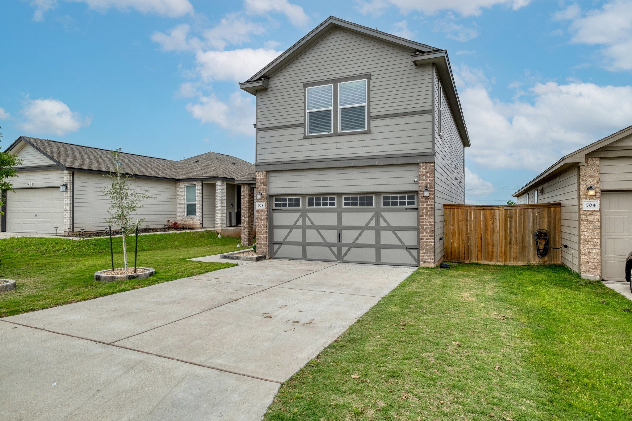 508 Barbary Coast Lane Jarrell, TX 76537 - Photo 26 of 27 a front view of a house with a yard and garage