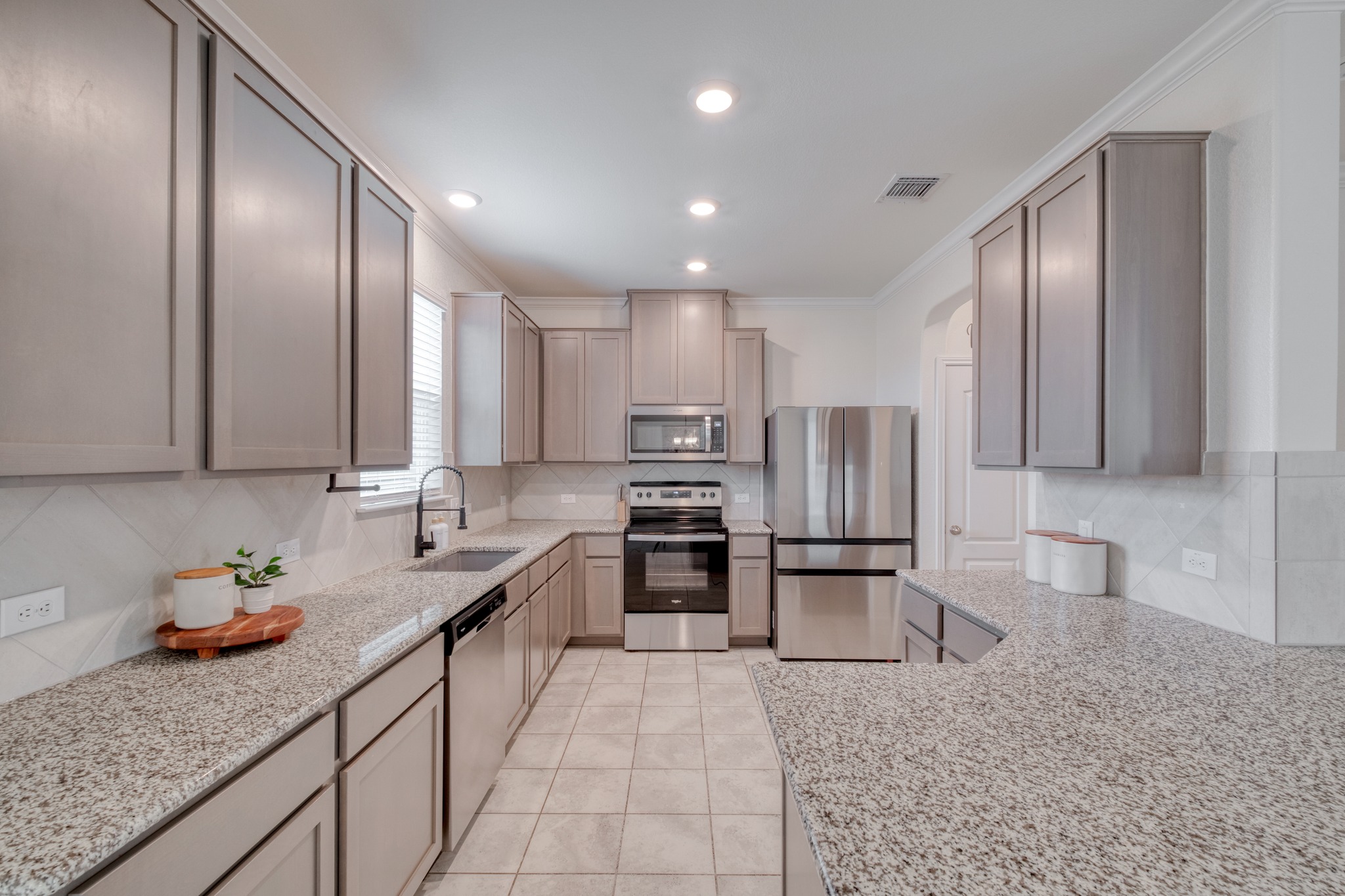 508 Barbary Coast Lane Jarrell, TX 76537 - Photo 7 of 27 a kitchen with stainless steel appliances granite countertop a refrigerator sink and cabinets
