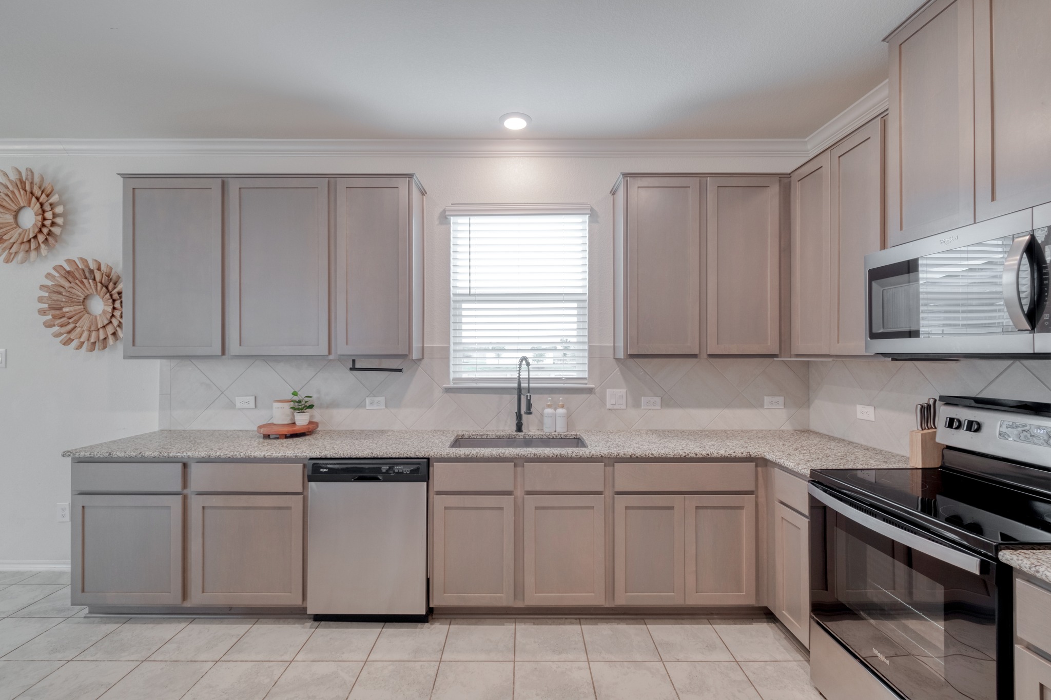 508 Barbary Coast Lane Jarrell, TX 76537 - Photo 8 of 27 a kitchen with cabinets appliances a sink and a window