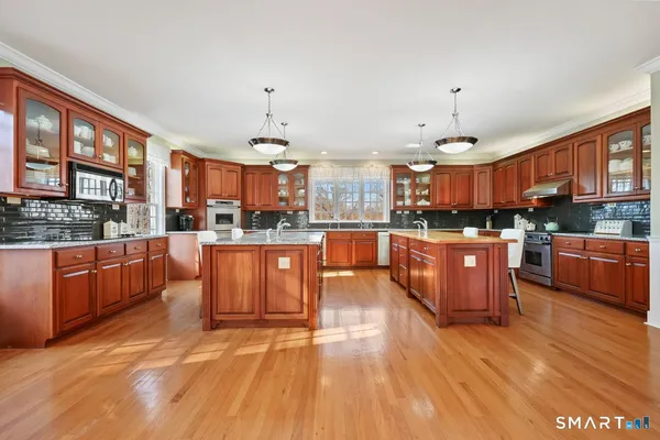 a large kitchen with stainless steel appliances kitchen island granite countertop a large counter top stainless steel appliances and cabinets