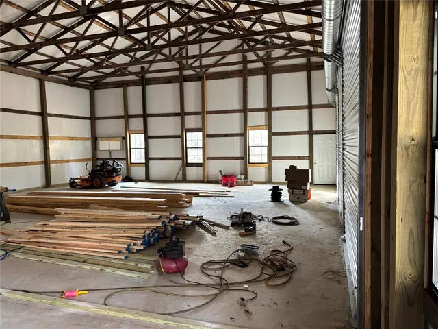 a living room with furniture and a floor to ceiling window