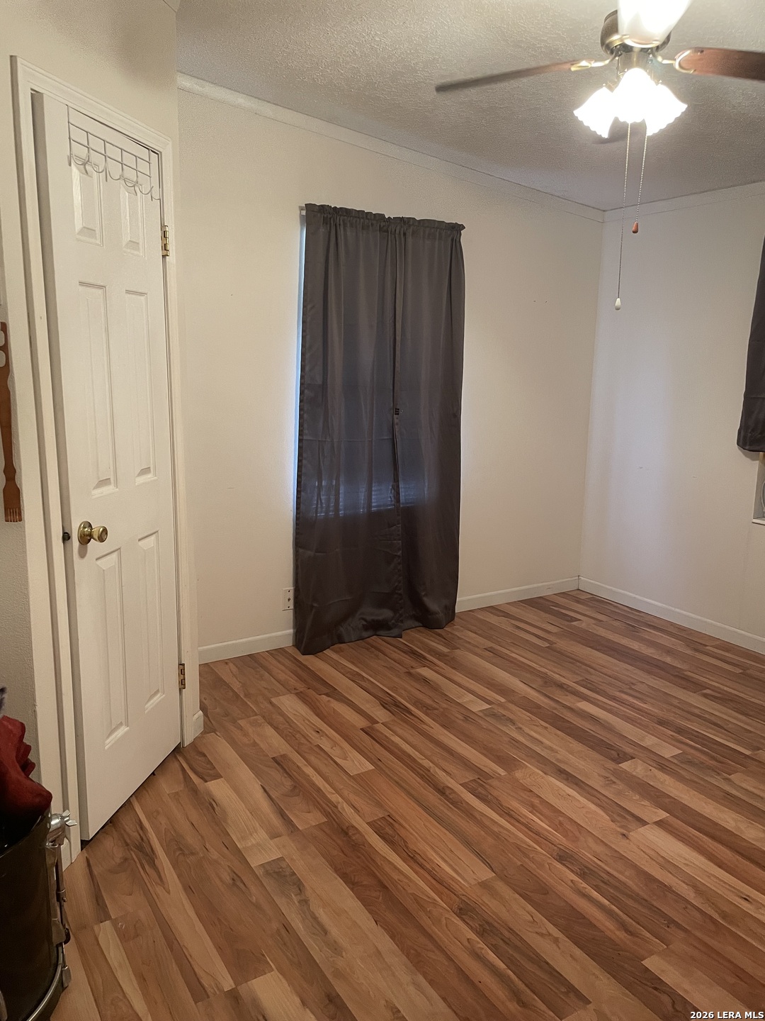 10280 Obrien Road Atascosa, TX 78002 - Photo 5 of 6 wooden floor in an empty room with a mirror