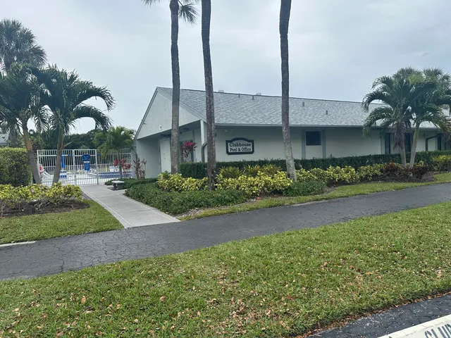 a front view of a house with a garden and plants