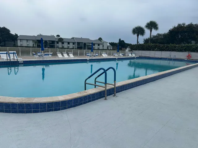 a view of a swimming pool with outdoor seating