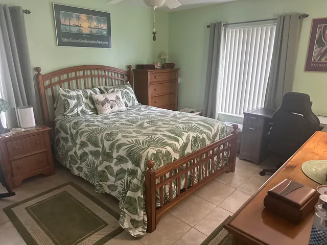 a bed sitting in a bedroom next to a window