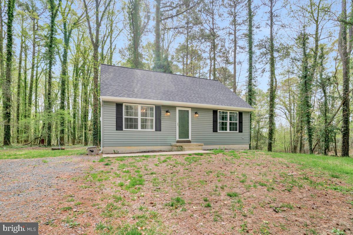7800 Marshall Road St. Leonard, MD 20685 - Photo 1 of 29 a front view of a house with a garden
