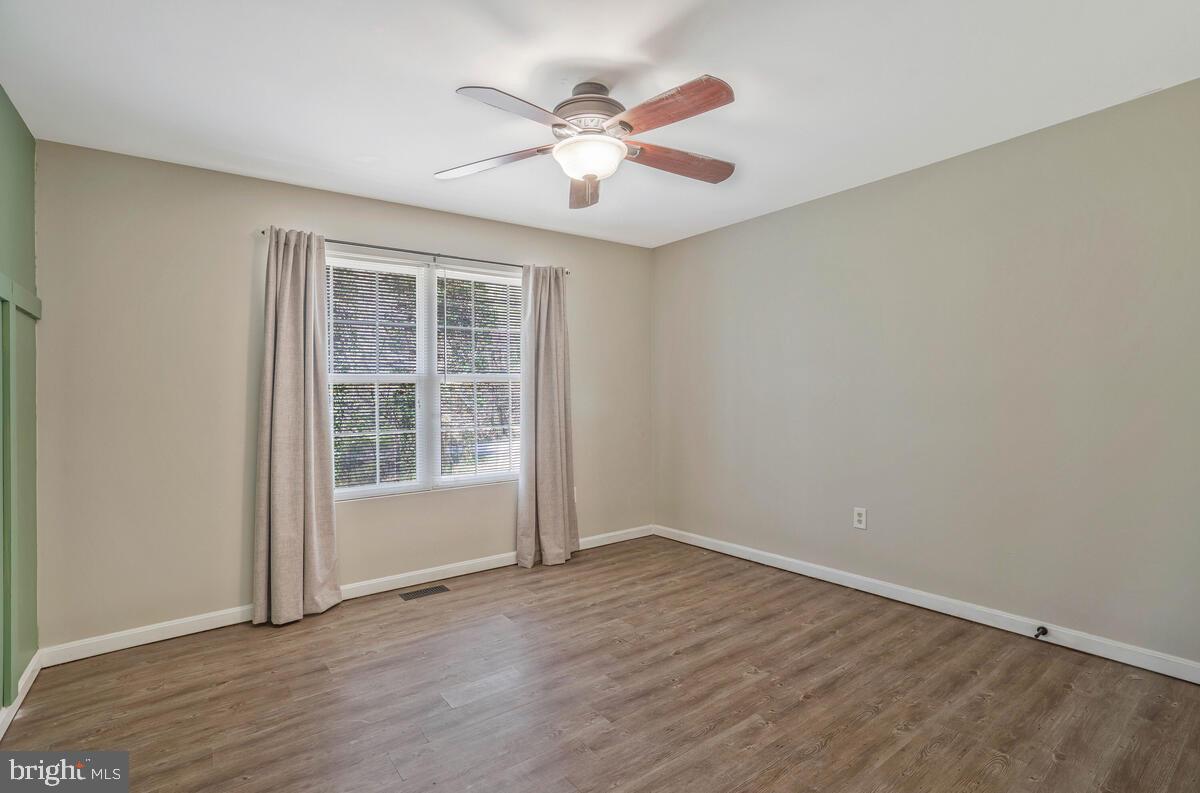 7800 Marshall Road St. Leonard, MD 20685 - Photo 25 of 29 an empty room with wooden floor and windows