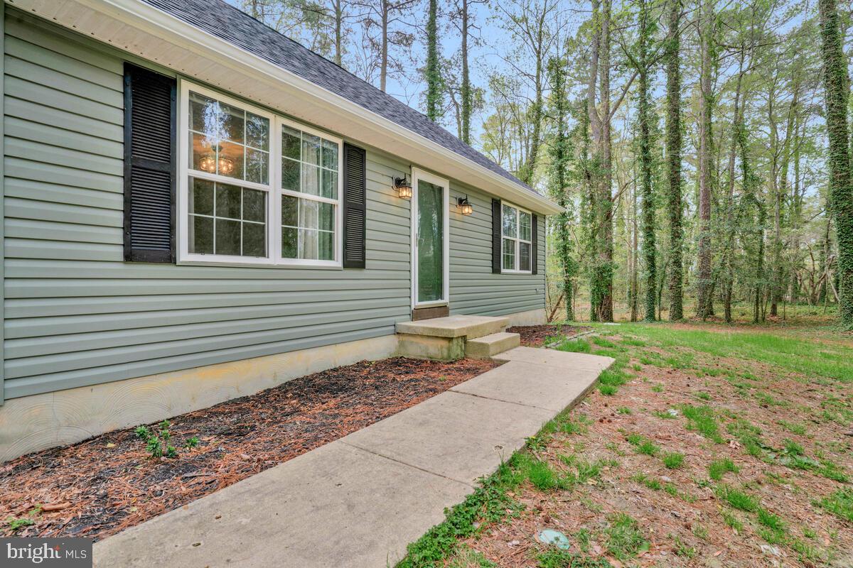 7800 Marshall Road St. Leonard, MD 20685 - Photo 4 of 29 a front view of a house with garden
