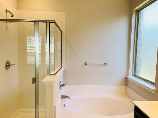 a bathroom with a bathtub and a shower