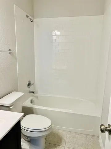 a bathroom with a toilet and a bathtub