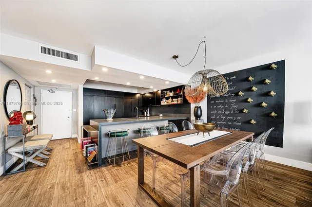 a living room with furniture kitchen view and a window