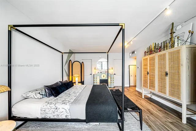 a bathroom with a granite countertop sink a mirror and shower