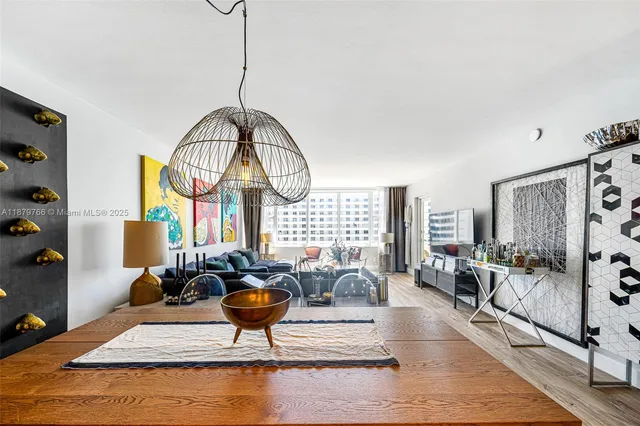 a living room with furniture a rug and a chandelier