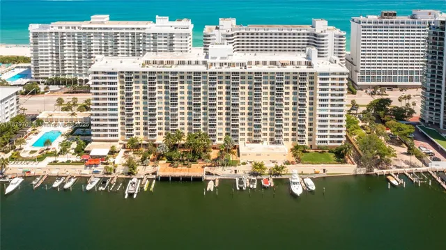a view of a patio with a table and chairs under an umbrella