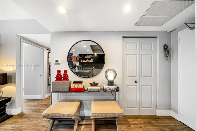 a living room with furniture and painting on the wall