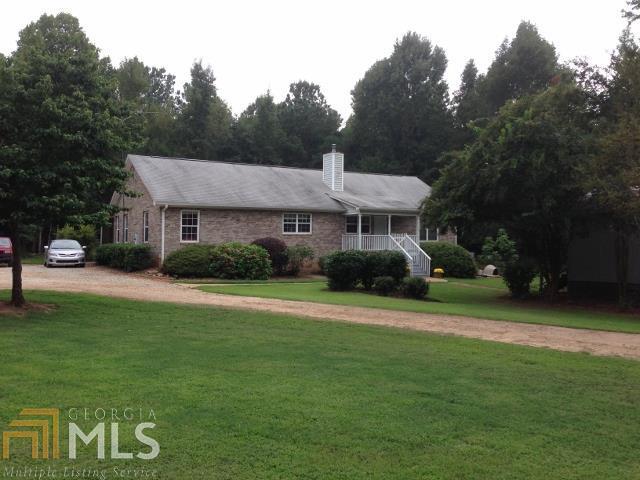4091 Eatonton Road Madison, GA 30650 - Photo 1 of 1 a front view of a house with a yard