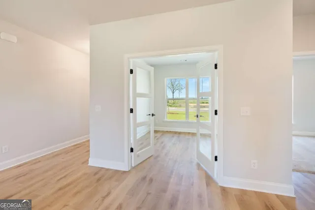 a view of hallway with wooden floor