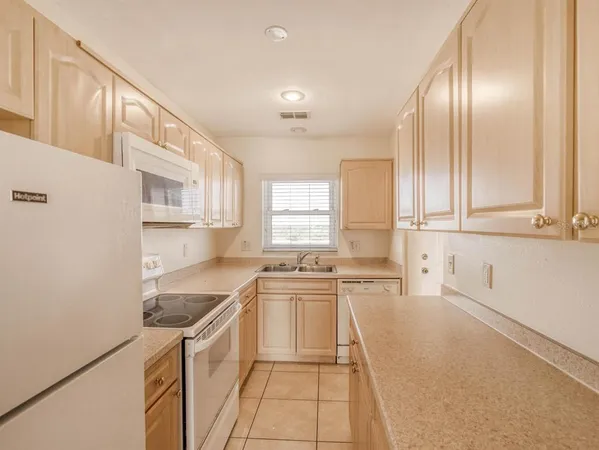 a kitchen with stainless steel appliances granite countertop a sink and cabinets
