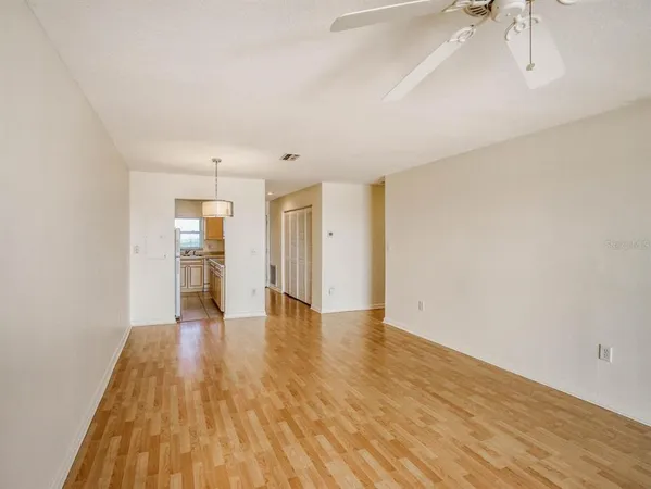 a view of empty room with wooden floor