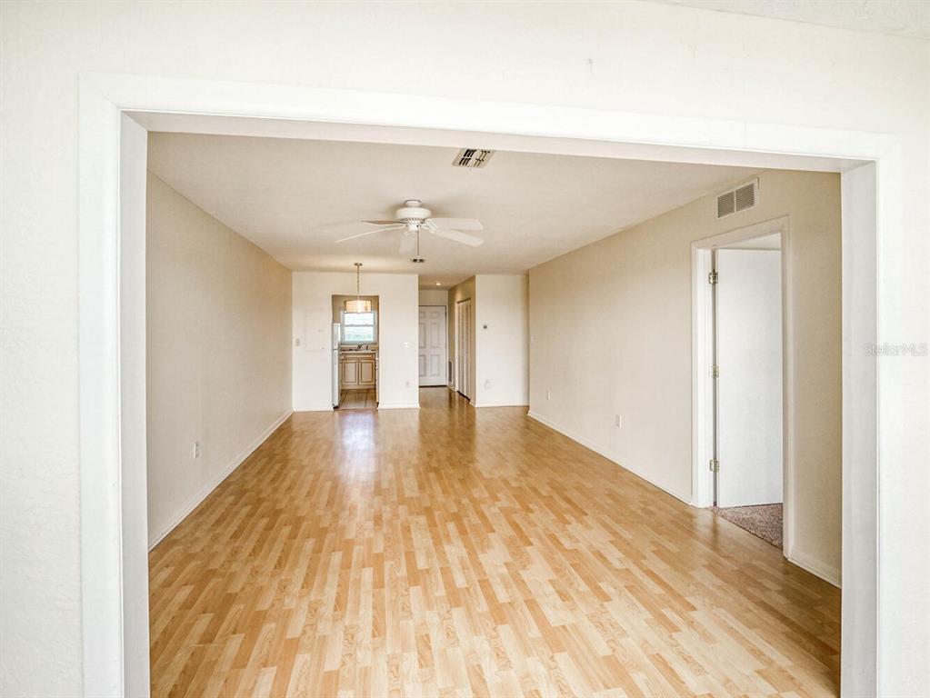 4939 Floramar Terrace, Unit 904 New Port Richey, FL 34652 - Photo 13 of 53 a view of an empty room and wooden floor
