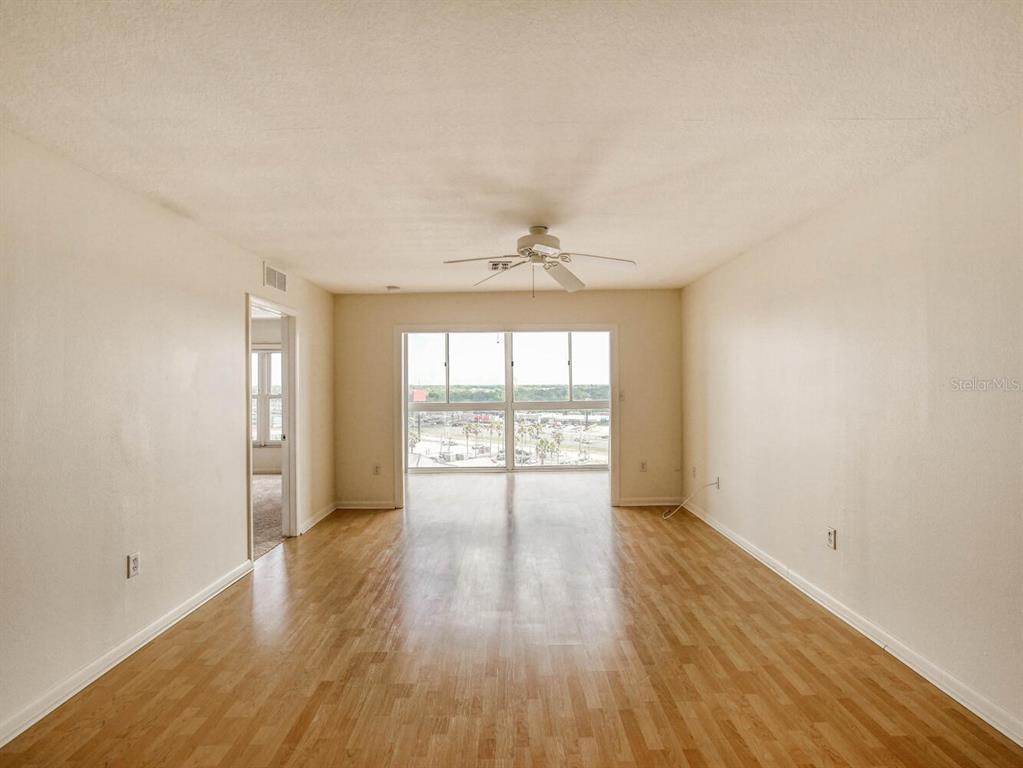4939 Floramar Terrace, Unit 904 New Port Richey, FL 34652 - Photo 15 of 53 wooden floor in an empty room with a window