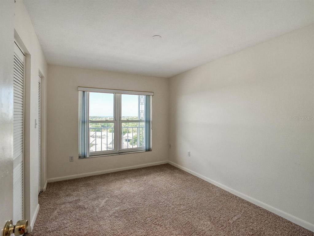4939 Floramar Terrace, Unit 904 New Port Richey, FL 34652 - Photo 29 of 53 an empty room with a window