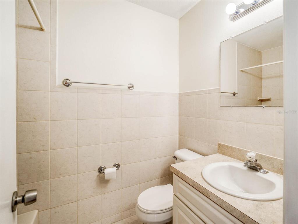 4939 Floramar Terrace, Unit 904 New Port Richey, FL 34652 - Photo 31 of 53 a bathroom with a sink toilet and shower