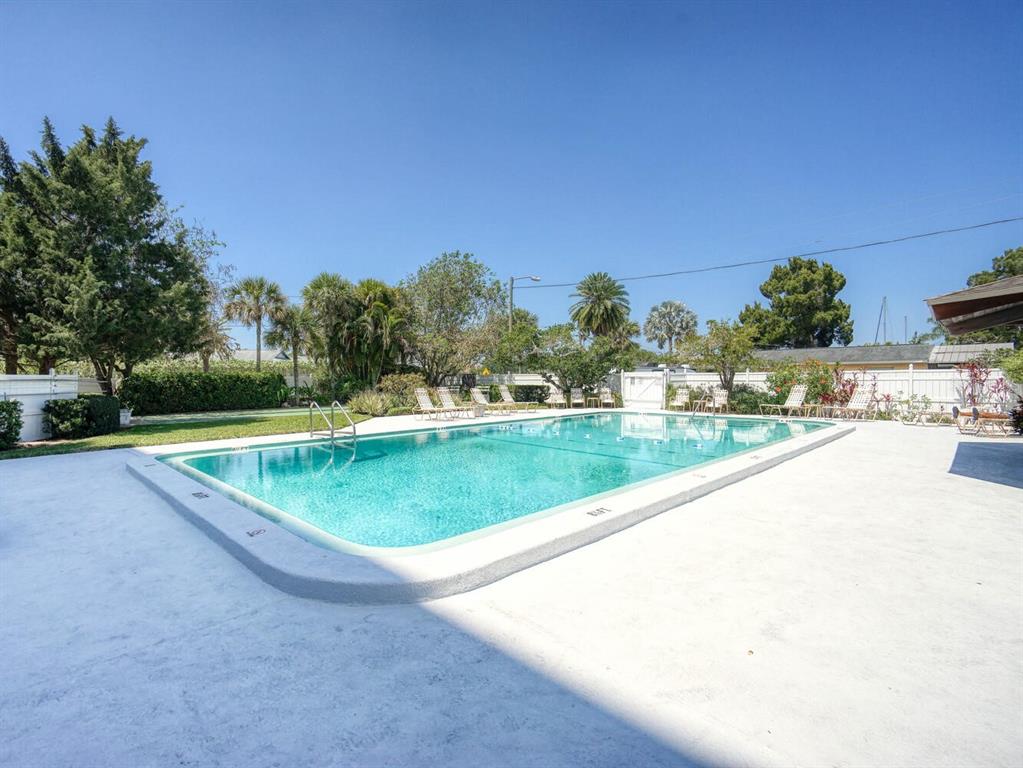 4939 Floramar Terrace, Unit 904 New Port Richey, FL 34652 - Photo 35 of 53 a view of a swimming pool and a yard
