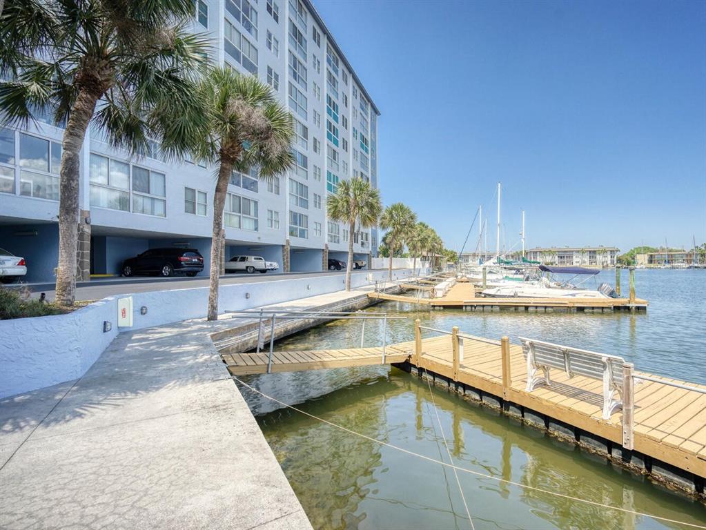 4939 Floramar Terrace, Unit 904 New Port Richey, FL 34652 - Photo 45 of 53 a swimming pool with outdoor seating and yard