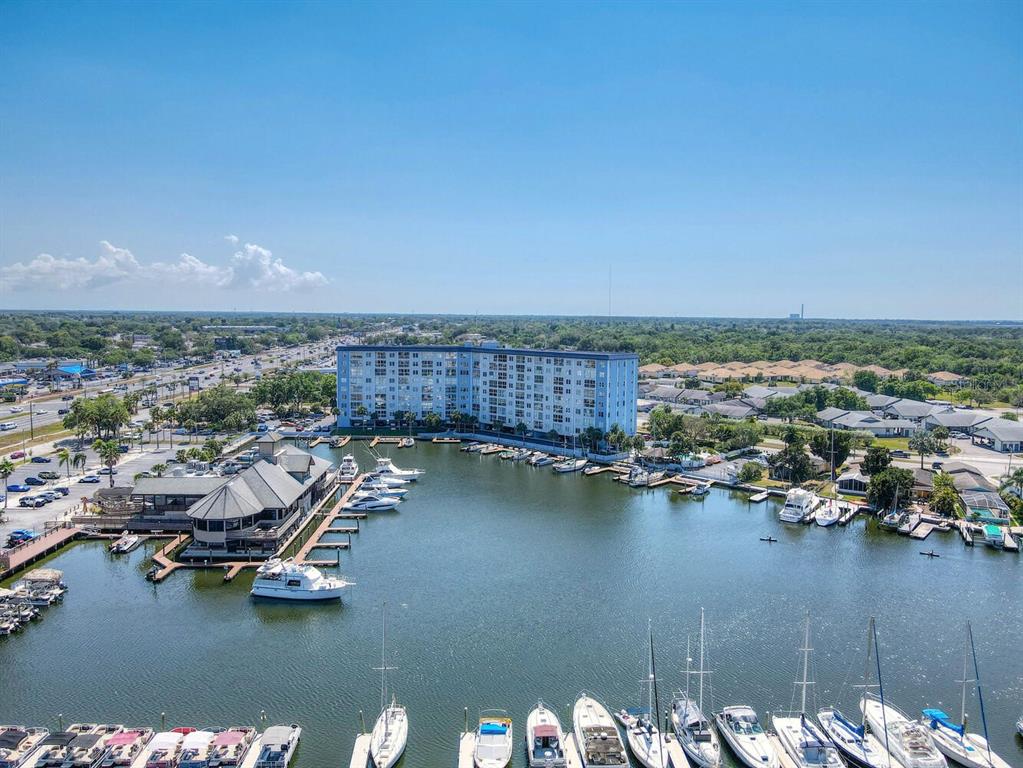 4939 Floramar Terrace, Unit 904 New Port Richey, FL 34652 - Photo 46 of 53 a view of a lake with multiple houses