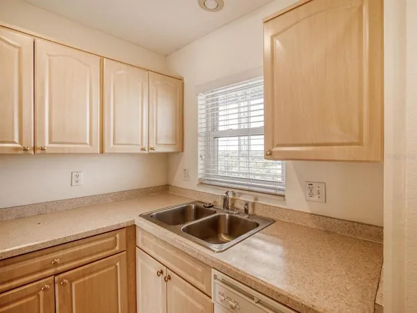 a kitchen with a sink cabinets and window
