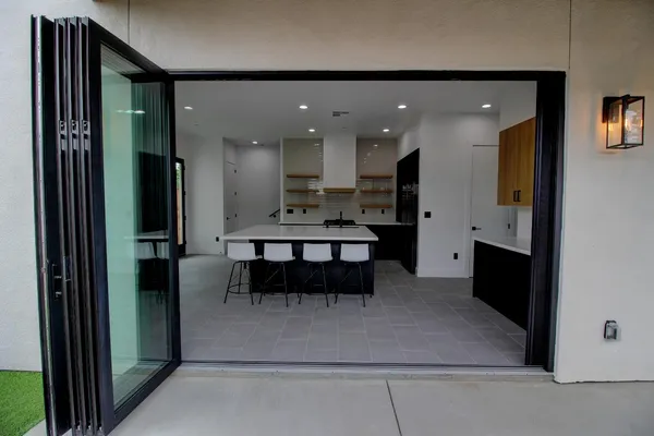 a view of kitchen with furniture and refrigerator