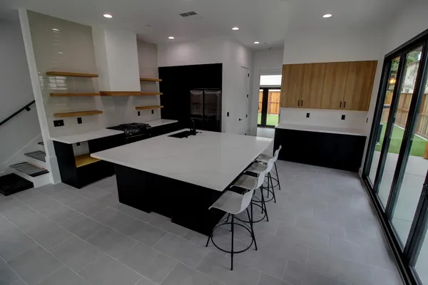 a large kitchen with a table and chairs in it