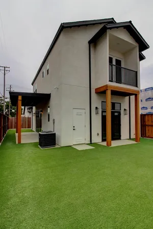 a view of a house with backyard porch and garden