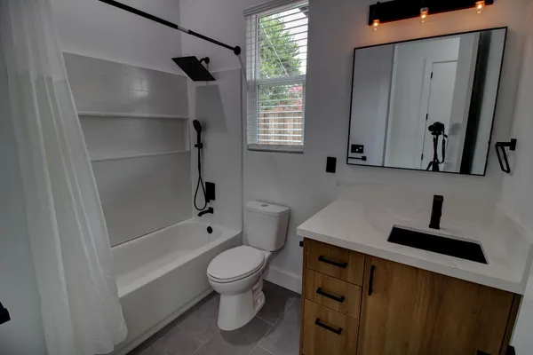 a bathroom with a toilet a sink and bathtub