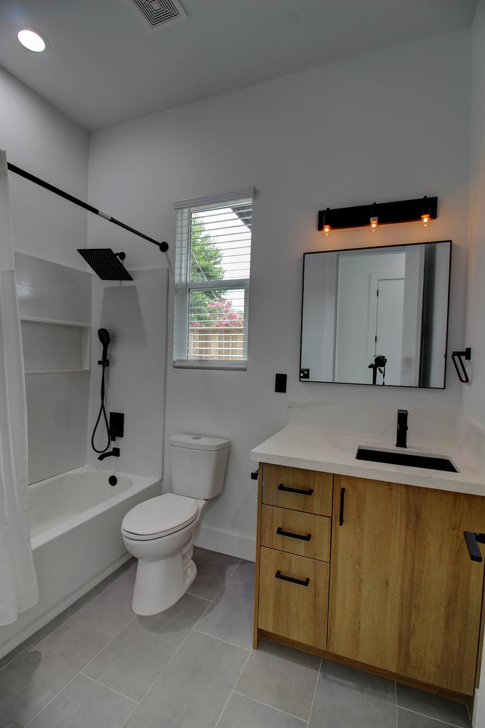 1526 3rd Street Escalon, CA 95320 - Photo 25 of 44 a bathroom with a sink toilet a mirror and bathtub