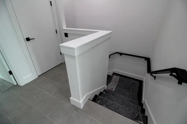 a utility room with mirror and tiles