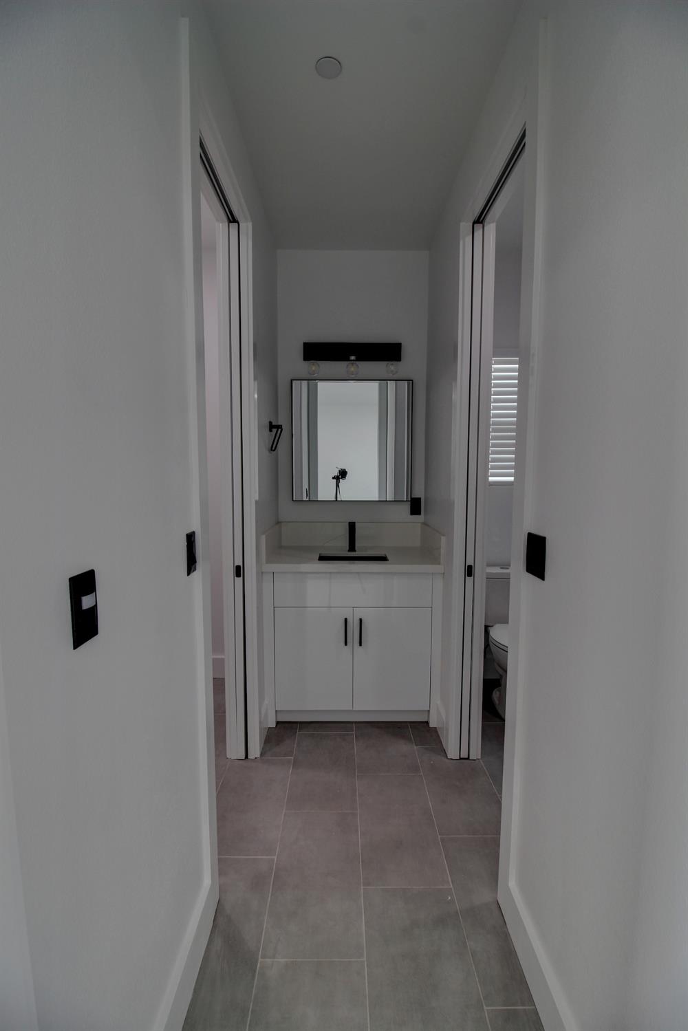 1526 3rd Street Escalon, CA 95320 - Photo 34 of 44 a bathroom with a double vanity sink and mirror