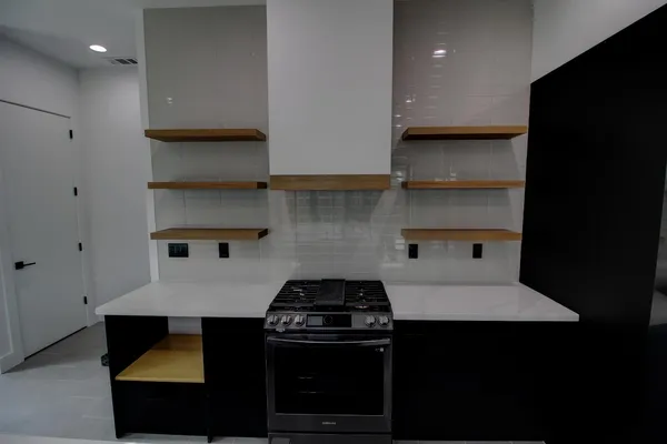 a kitchen with a stove and a refrigerator