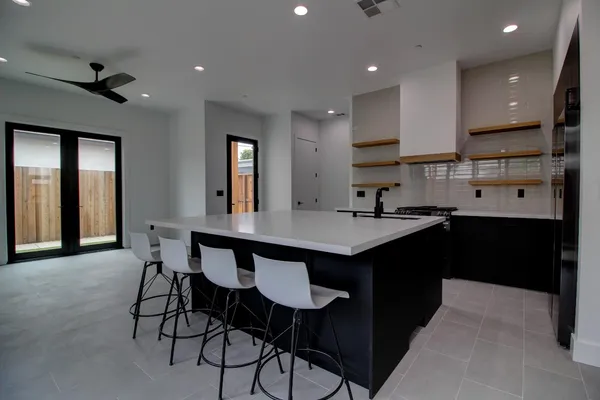 a kitchen with stainless steel appliances kitchen island granite countertop a sink and cabinets