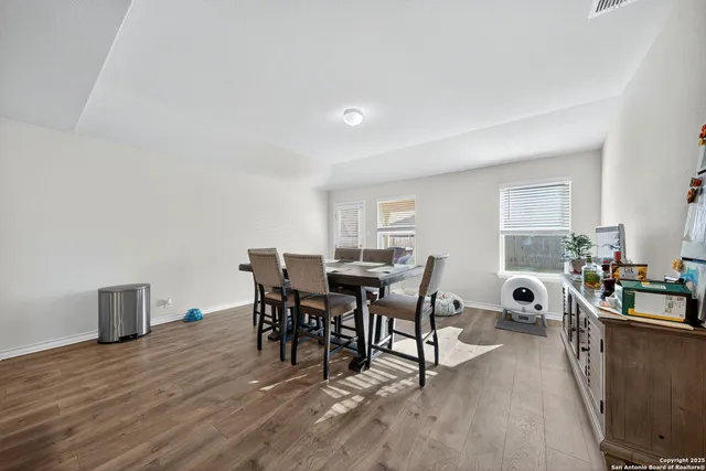 a view of a dining room with furniture and wooden floor