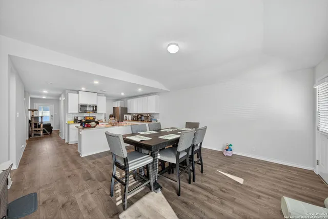 a view of a dining room with furniture and wooden floor