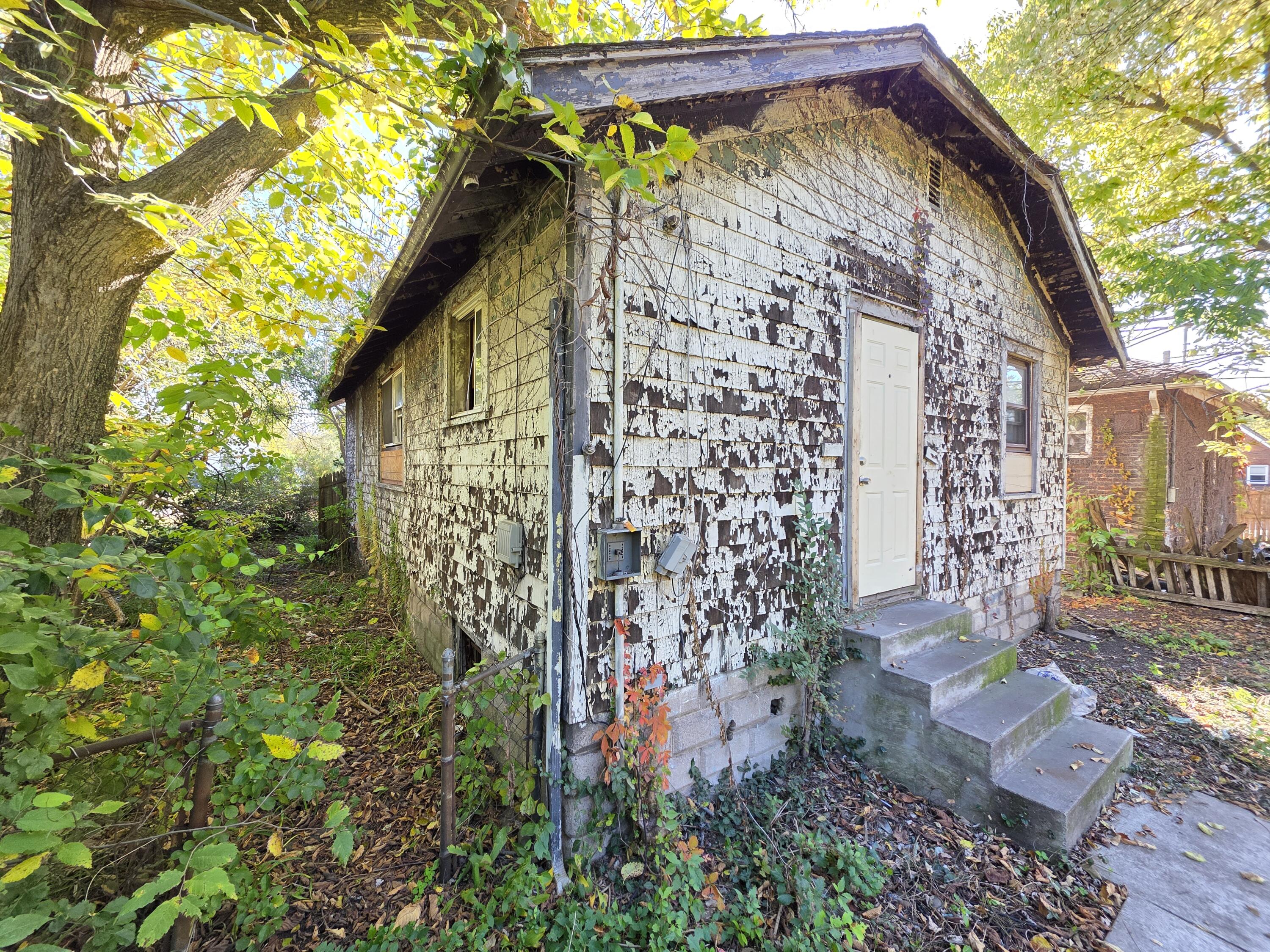 772 Ohio Street Gary, IN 46402 - Photo 11 of 22 a view of a pathway of a house with a tree
