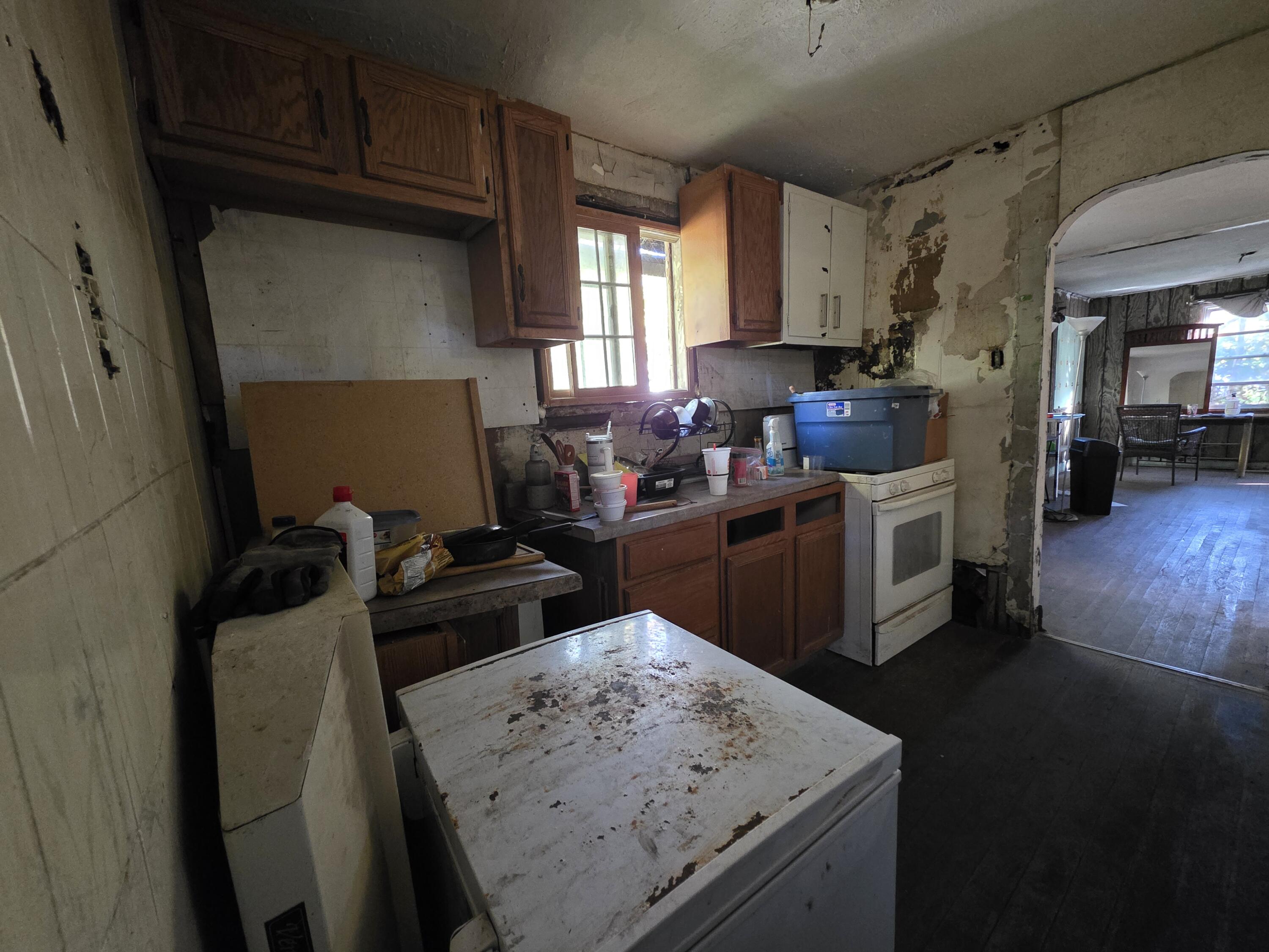 772 Ohio Street Gary, IN 46402 - Photo 15 of 22 a kitchen with a stove and a refrigerator
